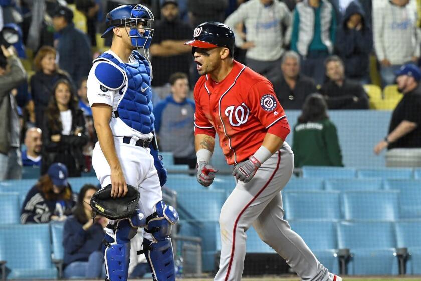 LOS ANGELES, CA - MAY 11: Austin Barnes #15 of the Los Angeles Dodgers looks on as Gerardo Parra #88 of the Washington Nationals celebrates as he crosses the plate after hitting a grand slam home run off Dylan Floro #51 of the Los Angeles Dodgers in the eighth inning of the game at Dodger Stadium on May 11, 2019 in Los Angeles, California. (Photo by Jayne Kamin-Oncea/Getty Images) ** OUTS - ELSENT, FPG, CM - OUTS * NM, PH, VA if sourced by CT, LA or MoD **