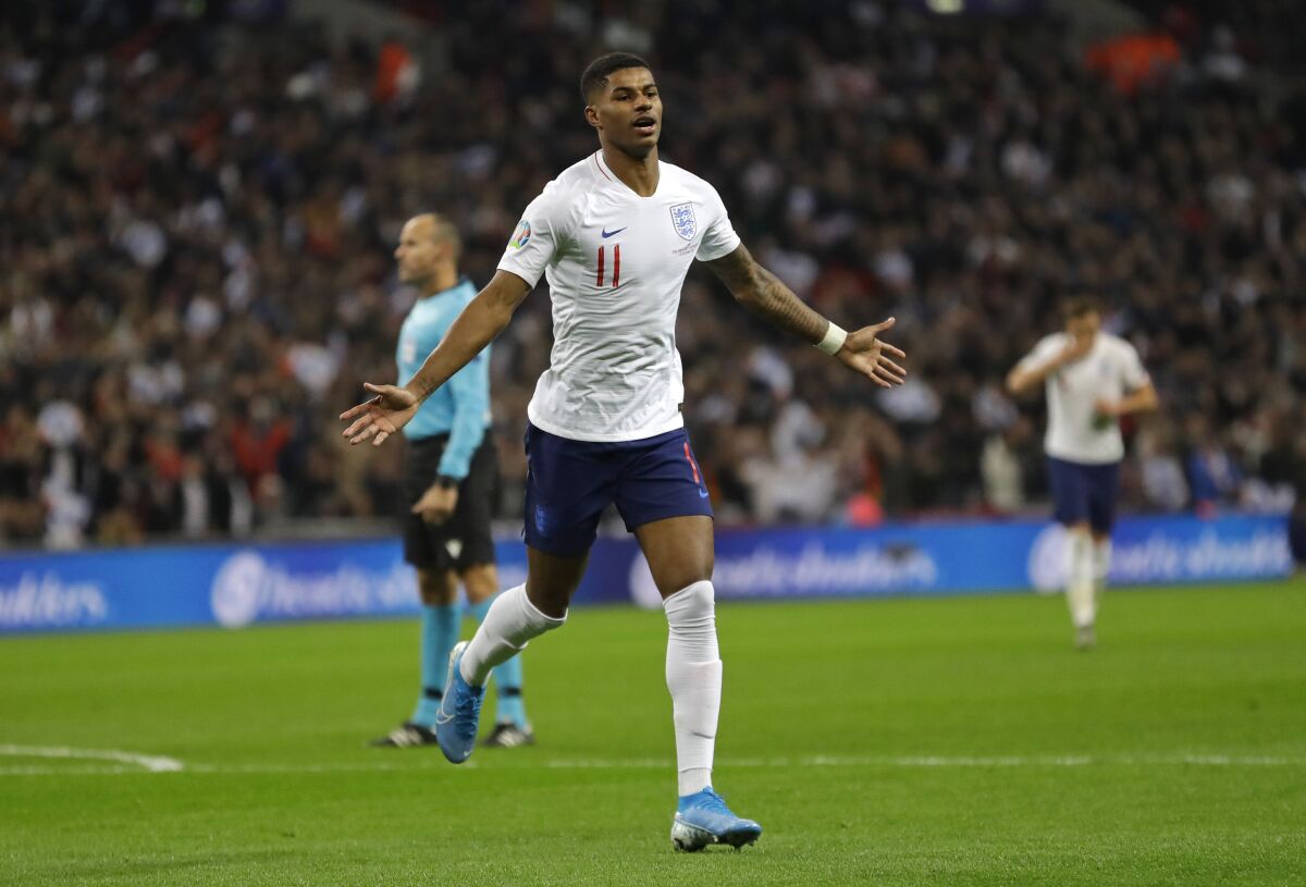FILE - In this Thursday, Nov. 14, 2019 filer, England's Marcus Rashford celebrates scoring his side's fourth goal during the Euro 2020 group A qualifying soccer match between England and Montenegro at Wembley stadium in London. (AP Photo/Kirsty Wigglesworth, File)
