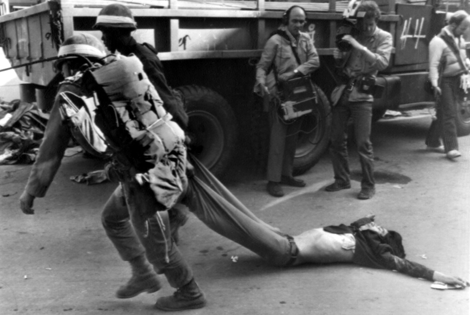 Soldiers drag away the body of a pro-democracy protester killed in a firefight