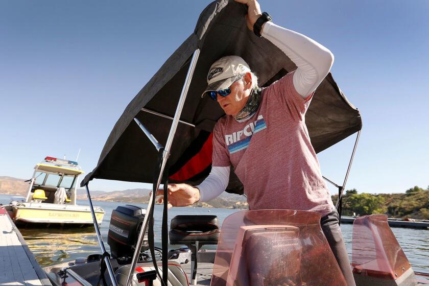CASTAIC, CA - JUNE 15, 2017 - Dan Curtis who has been fishing at Castaic Lake since 1985 prepares his fishing boat as he launches in this state water reservoir located just north of Santa Clarita on the Interstate 5 freeway on June 15, 2017. Castaic Lake offers a variety of Bass and other freshwater sport fish as it covers 2,235 acres with 29 miles of shoreline. (Al Seib / Los Angeles Times)