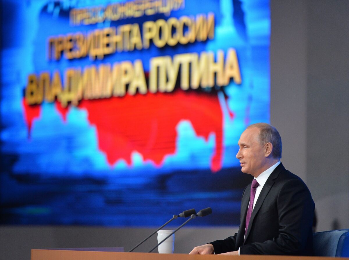 Russian President Vladimir Putin at his annual news conference on Dec. 18, speaking in front of a map of Russia that includes the Crimean peninsula annexed from Ukraine in March.