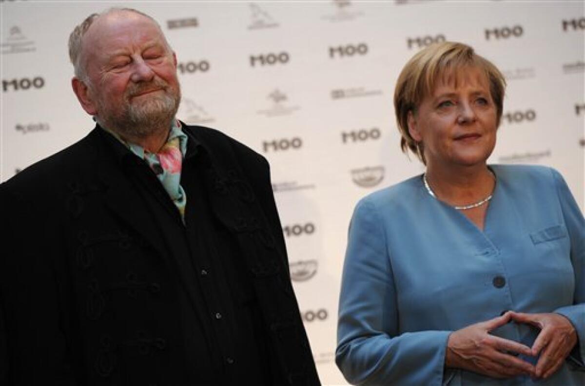 Danish cartoonist Kurt Westergaard, left, speaks with German Chancellor Angela Merkel before receiving the M100 Media Prize 2010 in Potsdam near Berlin, eastern Germany, Wednesday, Sept 8, 2010. Westergaard drew the most controversial of 12 caricatures of the Prophet Mohammed, first published in a Danish newspaper in 2005, which many Muslims considered offensive. (AP Photo/Odd Andersen, pool)