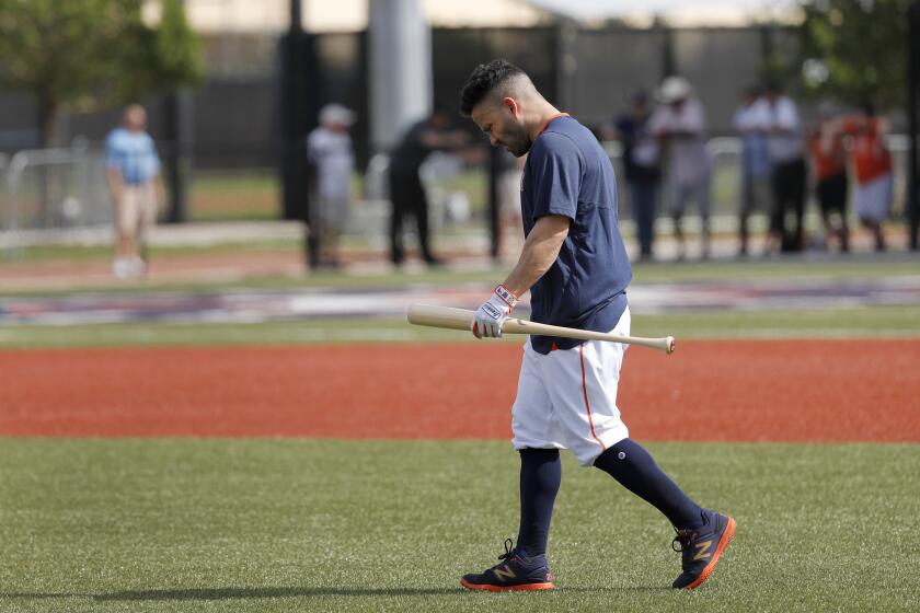 Houston Astros' Jose Altuve carries a bat as he heads out to hit during spring training baseball practice Thursday, Feb. 13, 2020, in West Palm Beach, Fla. (AP Photo/Jeff Roberson)