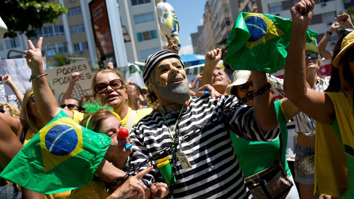 A demonstrator in the likeness of former Brazilian President Luiz Inacio Lula da Silva, in prison stripes, joins marchers in Rio de Janeiro last month to protest government corruption.