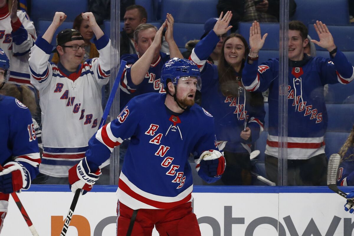 New York Rangers left wing Alexis Lafreniere (13) celebrates his goal during the second period of the team's NHL hockey game against the Buffalo Sabres, Friday, Dec. 10, 2021, in Buffalo, N.Y. (AP Photo/Jeffrey T. Barnes)