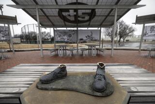 FILE - Bronze feet are left behind after the statue of legendary baseball pioneer Jackie Robinson was stolen from a park in Wichita, Kan., early Jan. 25, 2024. A 45-year-old man has pleaded guilty in the theft of the statue that was cut off at the ankles and found days later smoldering in a trash can in a city park in Kansas. (Travis Heying/The Wichita Eagle via AP, File)