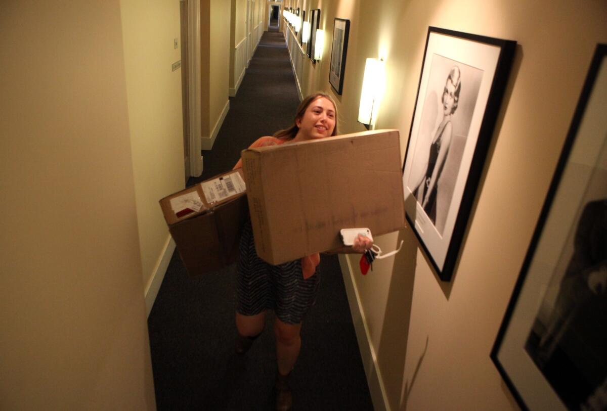 "Witches of East End" production assistant Amy Thurlow carries boxes from the mailroom at Sunset Bronson Studios in Hollywood in 2014.