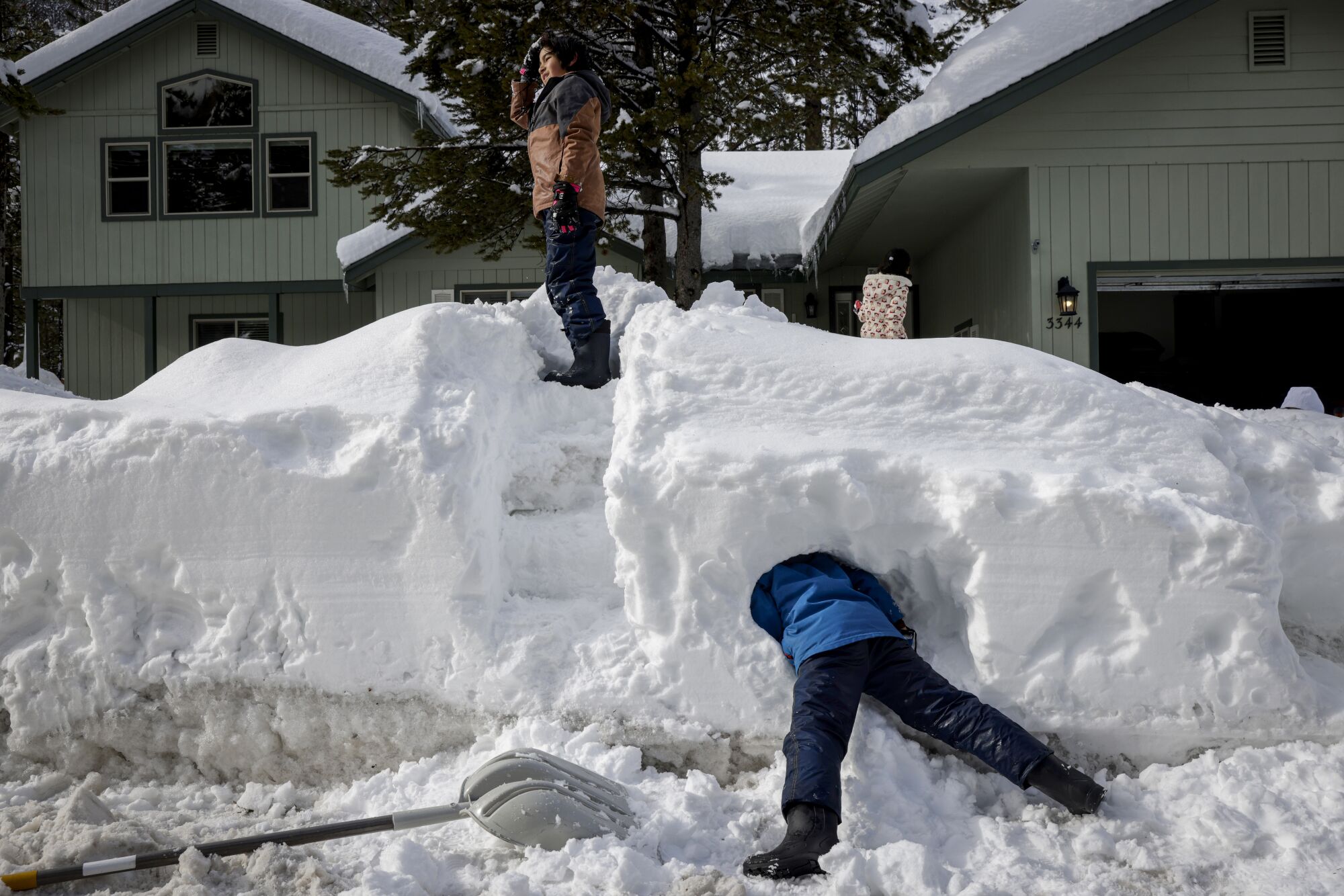 Boys play in the snow Wednesday in a community near South Lake Tahoe.