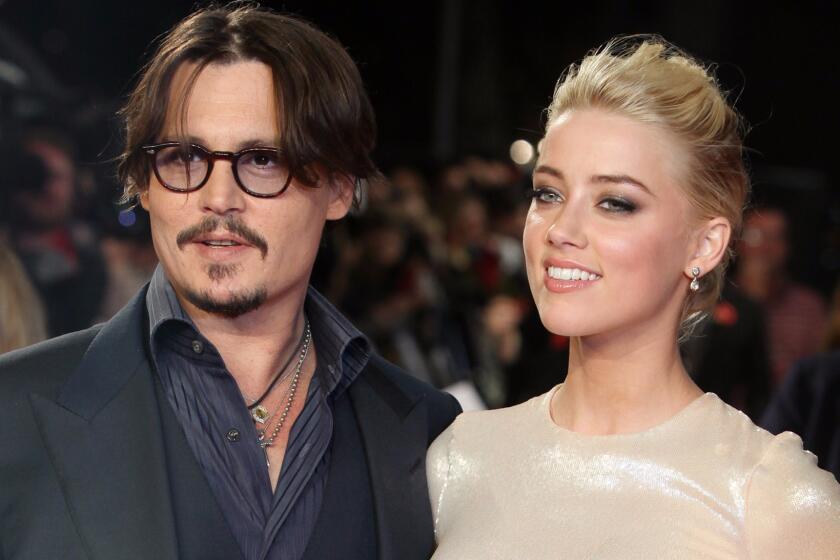 Actors Johnny Depp, left, and Amber Heard attend "The Rum Diary" premiere in London on Nov. 3, 2011.