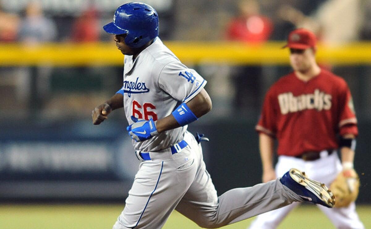 Dodgers right fielder Yasiel Puig rounds the bases after hitting a home run against the Arizona Diamondbacks on Sept. 18. The Dodgers and Diamondbacks will have plenty of on-field meetings between one another over the next six weeks.