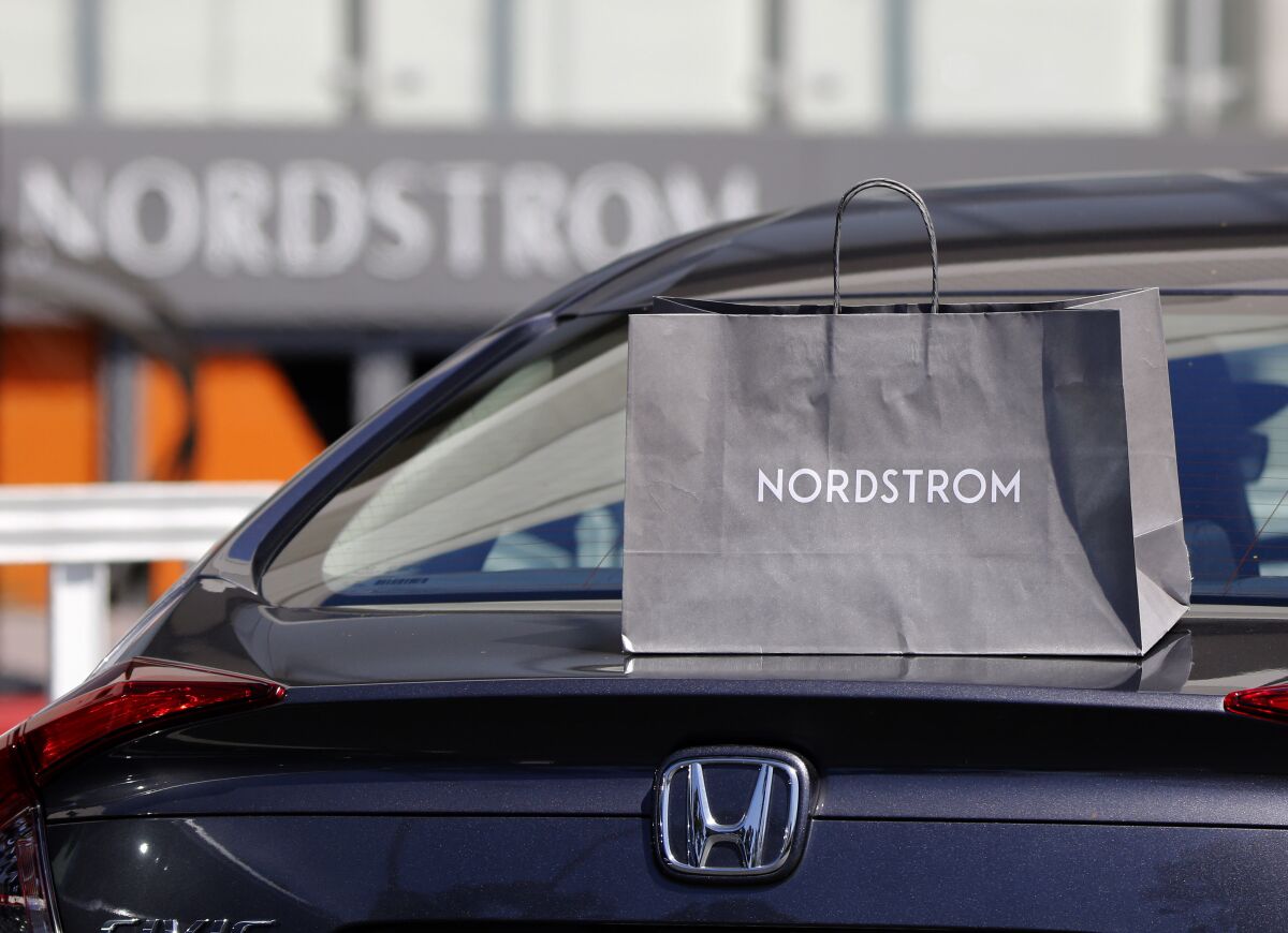 A Nordstrom service employee left an order for a customer on top of the car's trunk when the trunk did not open automatically at South Coast Plaza in Costa Mesa on Friday.