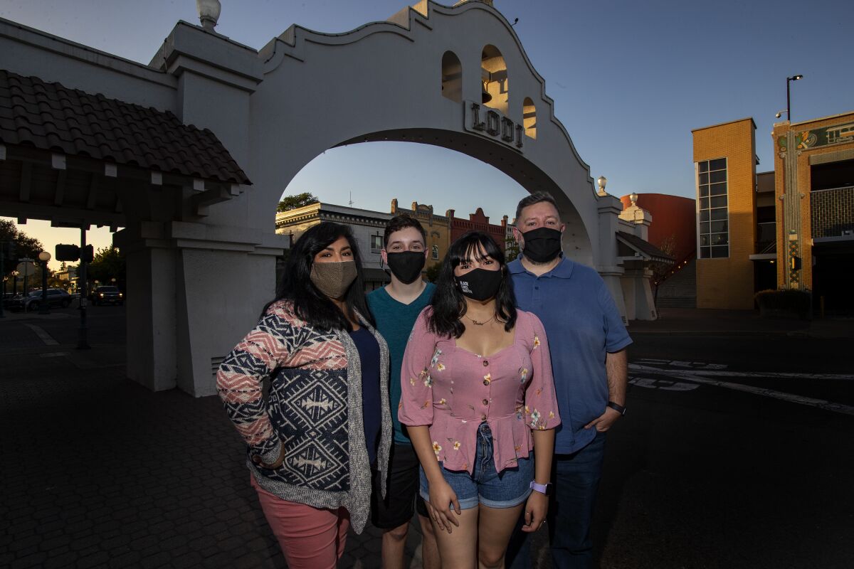 The Ditmore family stands beside Lodi's picturesque city archway.