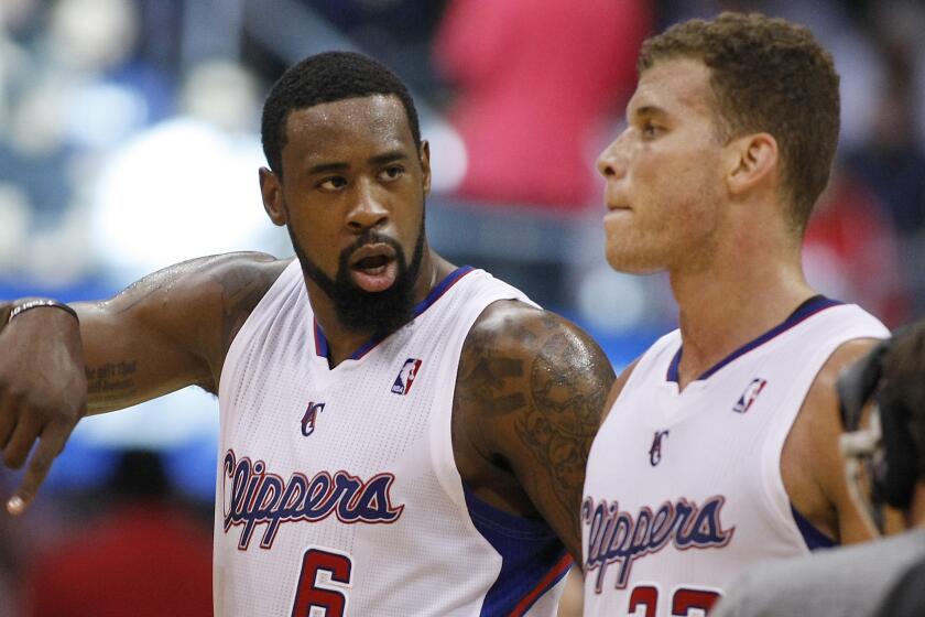 Clippers center DeAndre Jordan, left, speaks with teammate Blake Griffin during a game against the Dallas Mavericks in April.