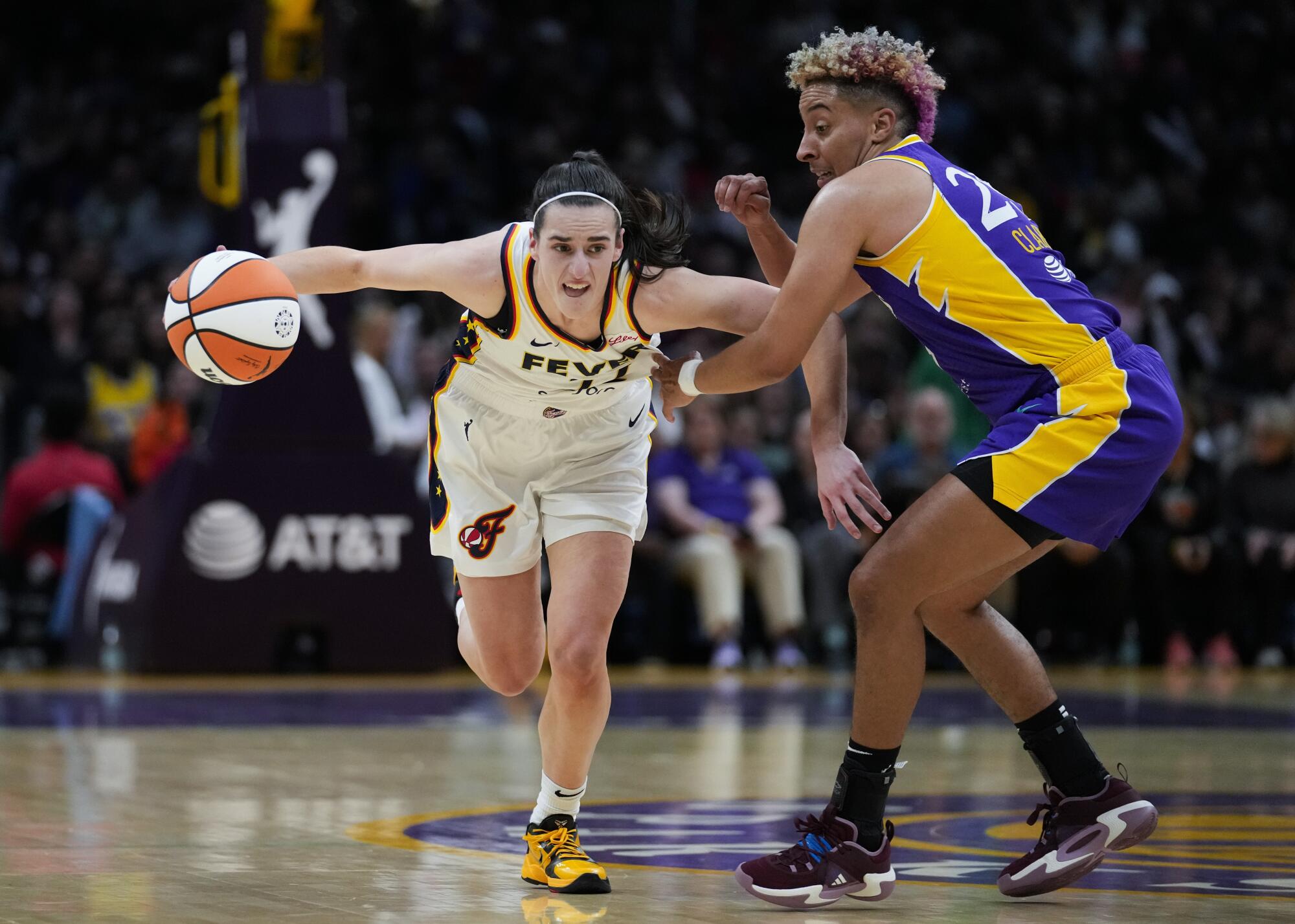 Sparks guard Layshia Clarendon guards Indiana Fever guard Caitlin Clark in Los Angeles Friday.