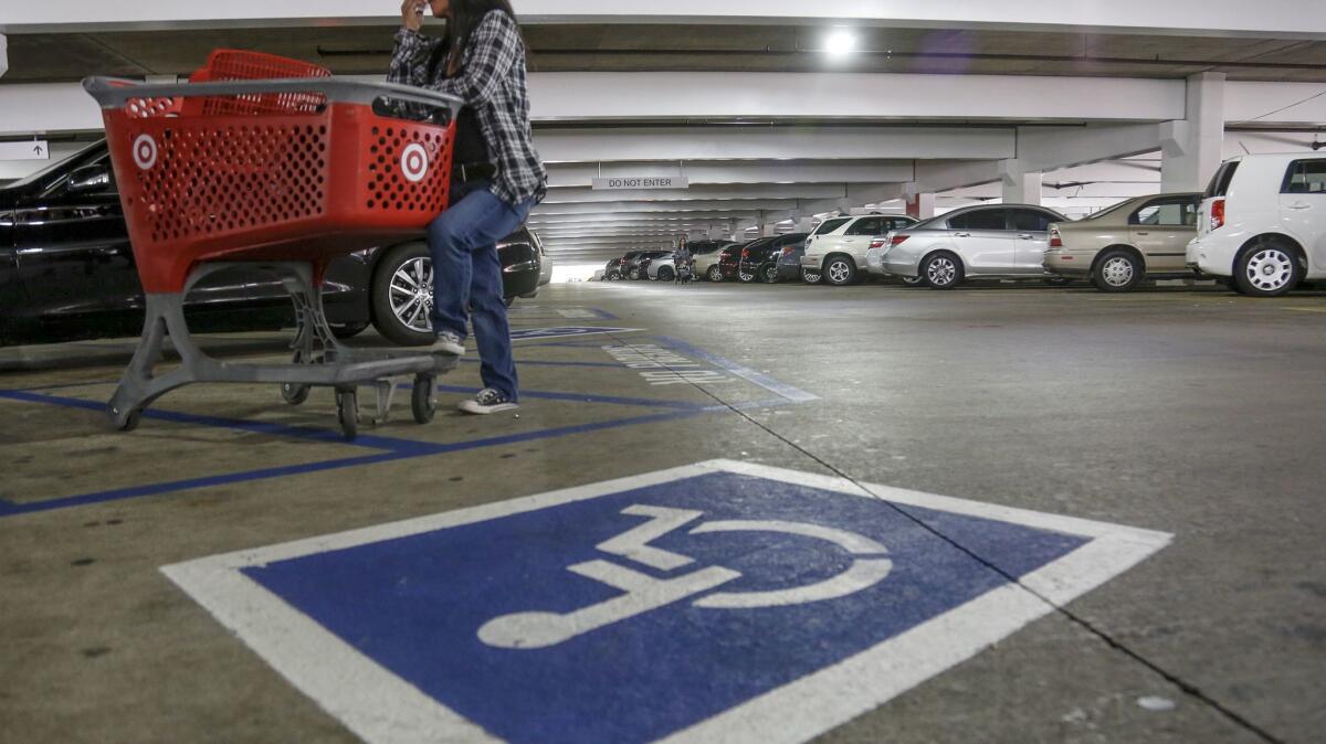 An undercover DMV officer waits at the Glendale Galleria during a sting on the improper use of disabled placards.
