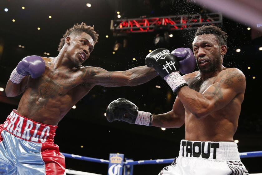 Jermall Charlo lands a left against Austin Trout during their IBF super-welterweight title fight in Las Vegas on Saturday.