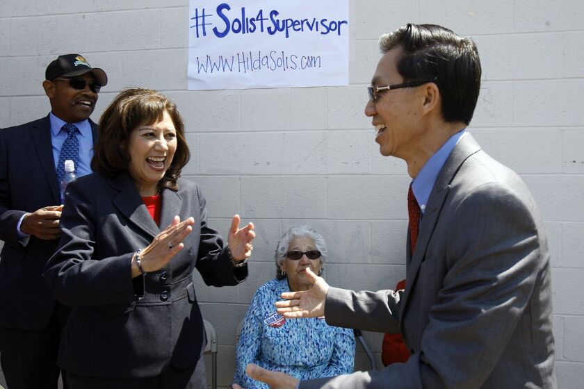 Hilda Solis campaigns in El Monte in April. Solis is seen greeting Assemblyman Ed Chau; her mother, Juana Solis, looks on.