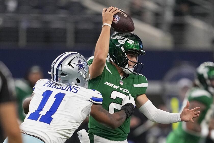 New York Jets quarterback Zach Wilson is sacked by Dallas Cowboys linebacker Micah Parsons during the second half of an NFL football game in Arlington, Texas, Sunday, Aug. 17, 2023. (AP Photo/Tony Gutierrez)