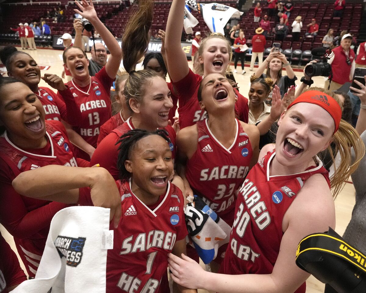 Sacred Heart's Olivia Tucker and Ny'Ceara Pryor celebrate with teammates after a 57-47 victory against Southern.