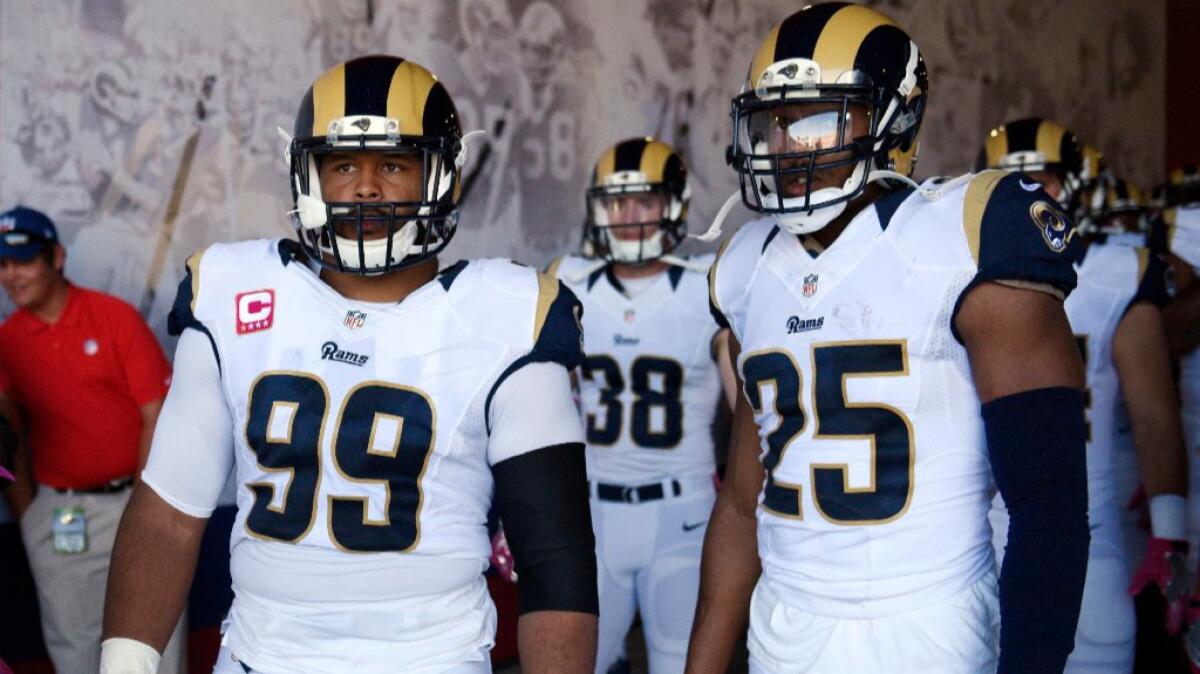 Rams defensive tackle Aaron Donald, left, and safety T.J. McDonald look on before a game against the Bills on Oct. 9.