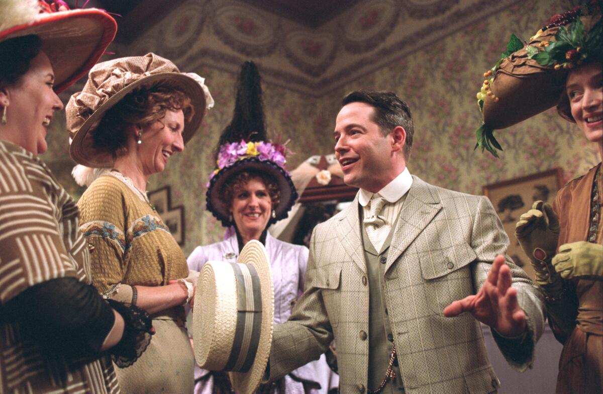 Matthew Broderick is seen holding a straw hat and surrounded by women in a scene from "The Music Man"