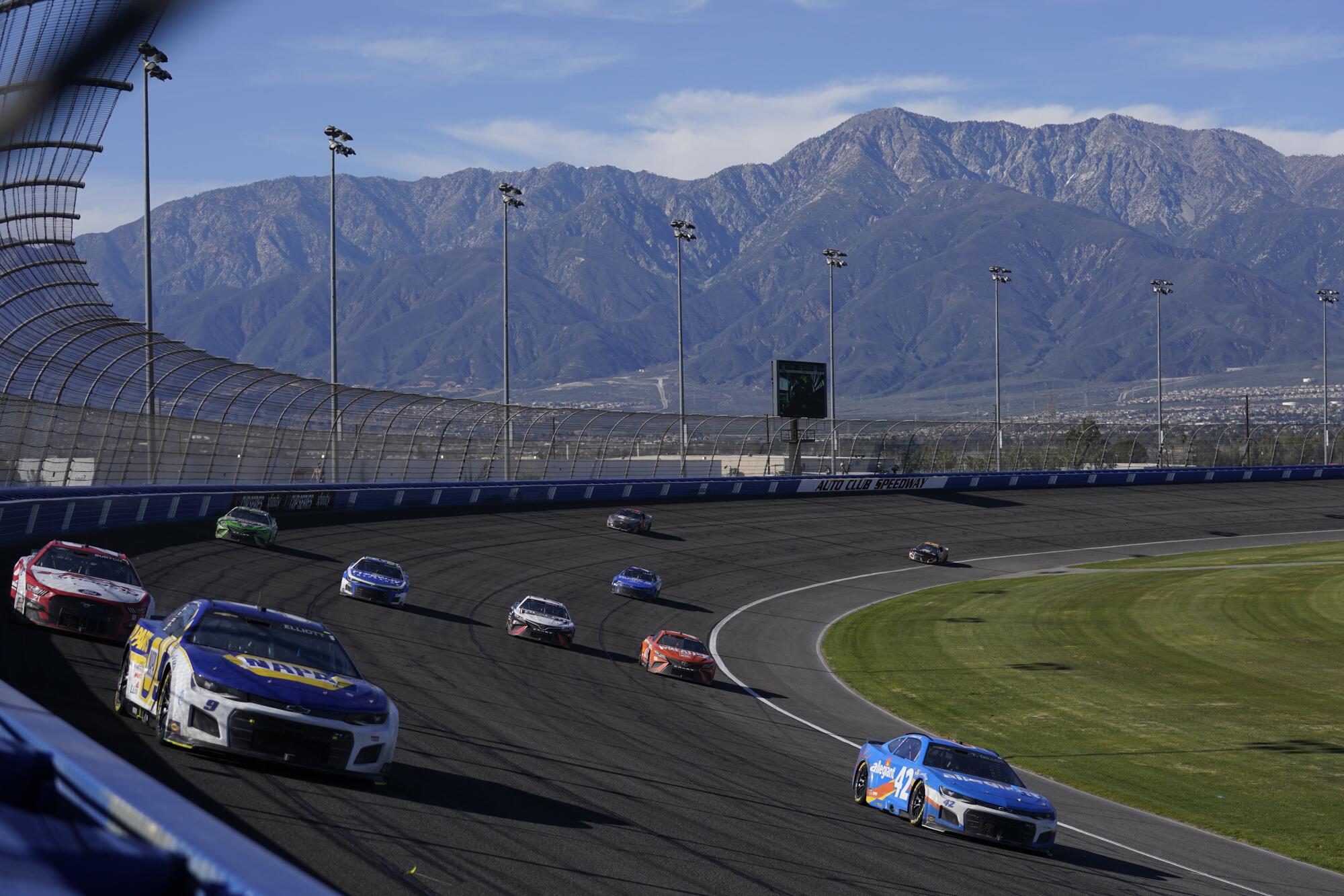 Chase Elliott, top left, leads a pack of driver during the 2022 NASCAR Cup Series race at Auto Club Speedway in Fontana.