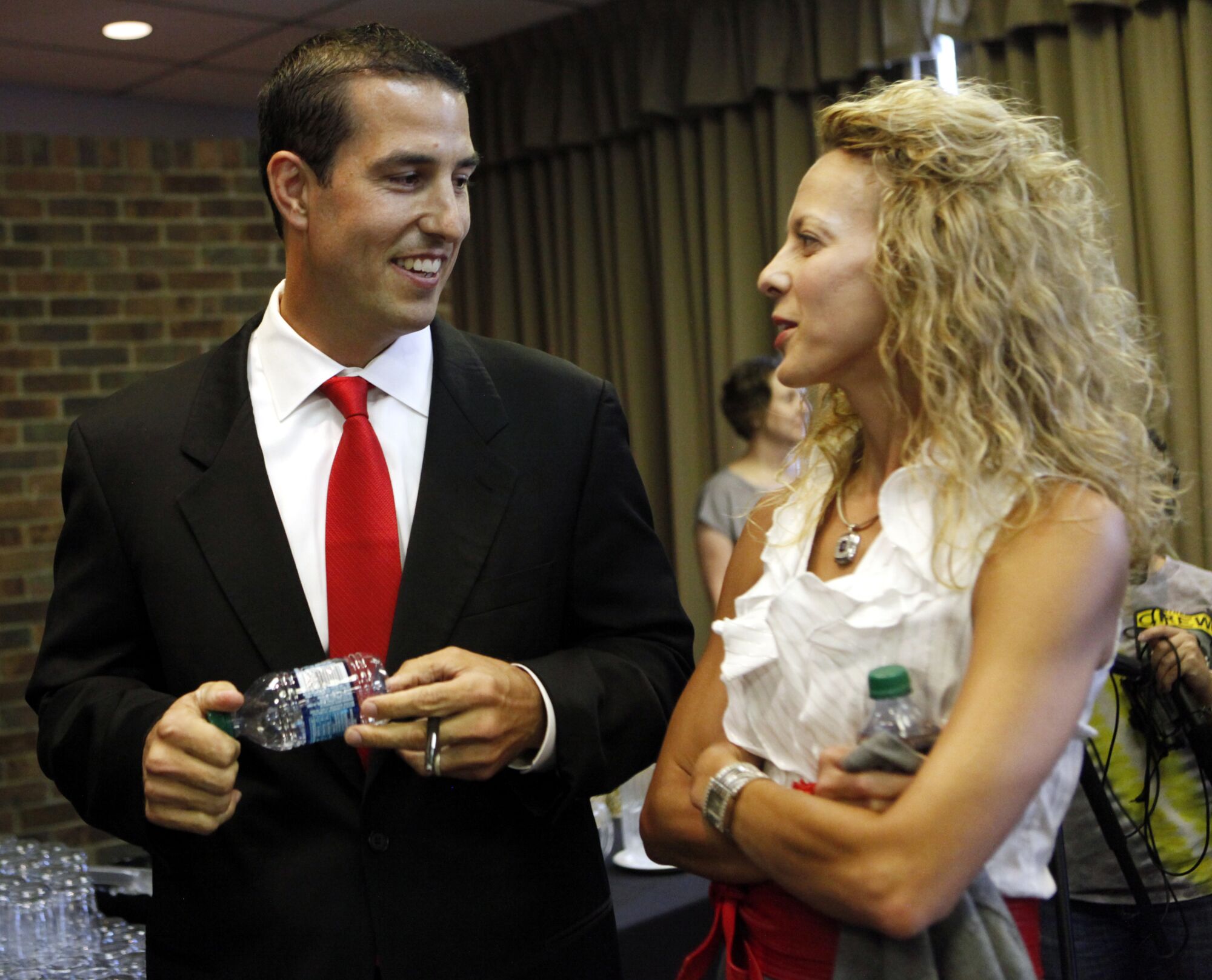 Ohio State coach Luke Fickell, left, shares a moment with his wife, Amy, before a 2011 news conference