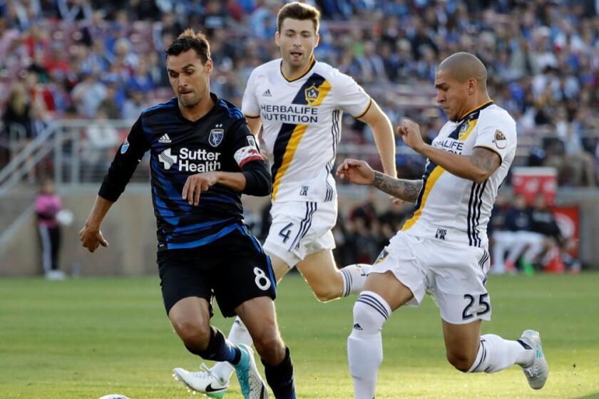 San Jose Earthquakes forward Chris Wondolowski (8) is chased by Los Angeles Galaxy defenders Dave Romney (4) and Rafael Garcia (25) during the first half of an MLS soccer match Saturday, July 1, 2017, in San Jose, Calif. (AP Photo/Marcio Jose Sanchez)