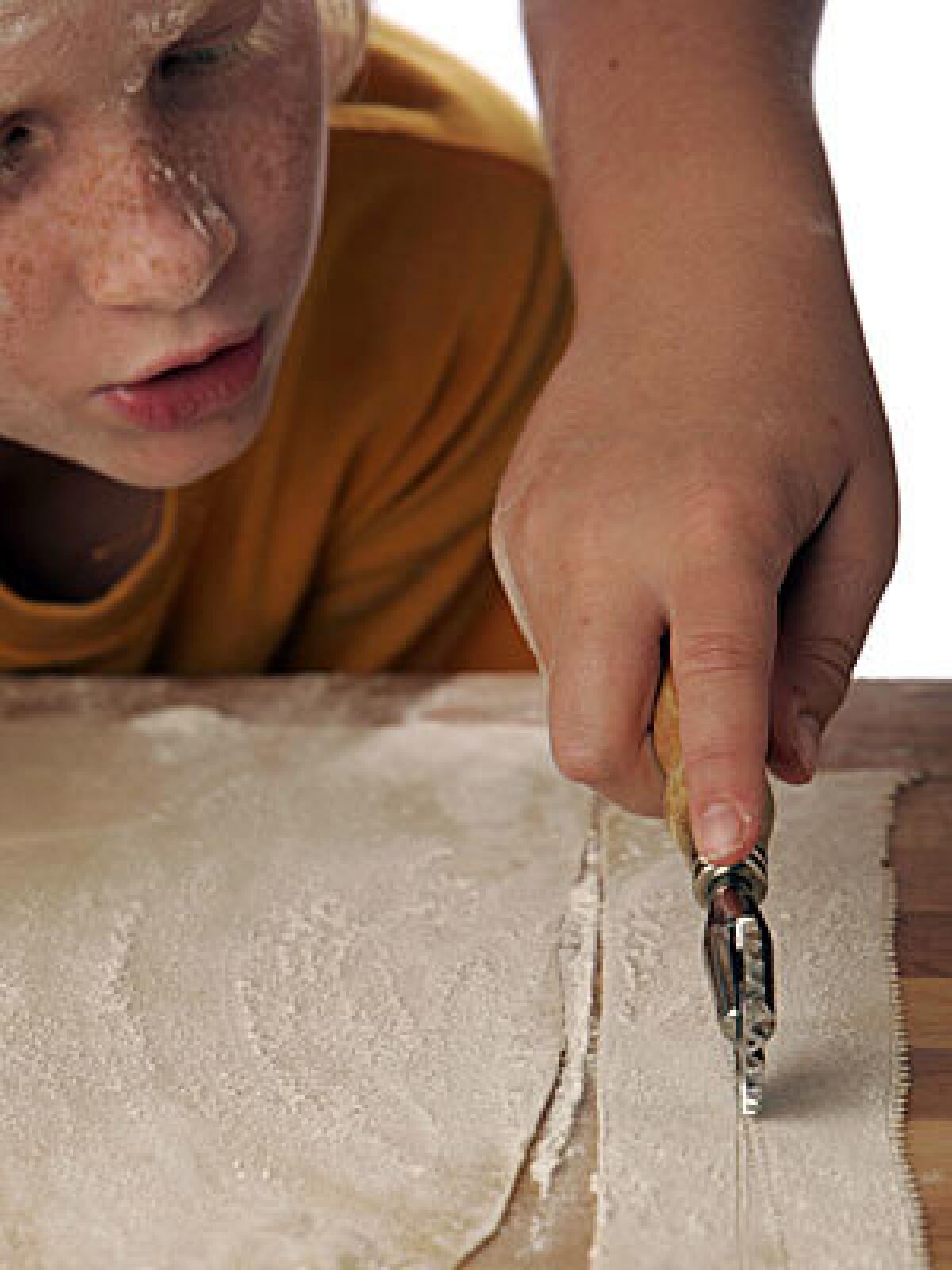 USING THEIR NOODLES: Kneading, rolling, cutting dough. It's a job made for kids.