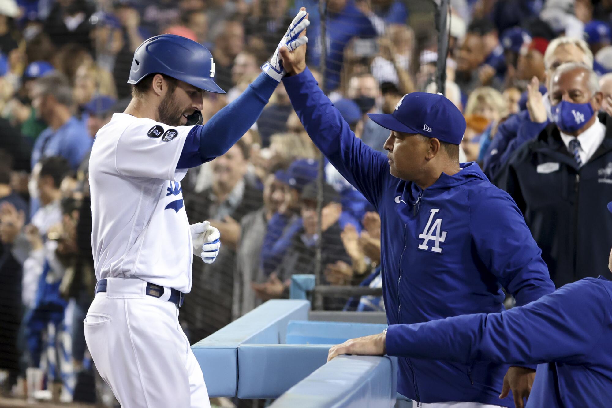 Chris Taylor celebrates with manager Dave Roberts after hitting a solo home run during the seventh inning.