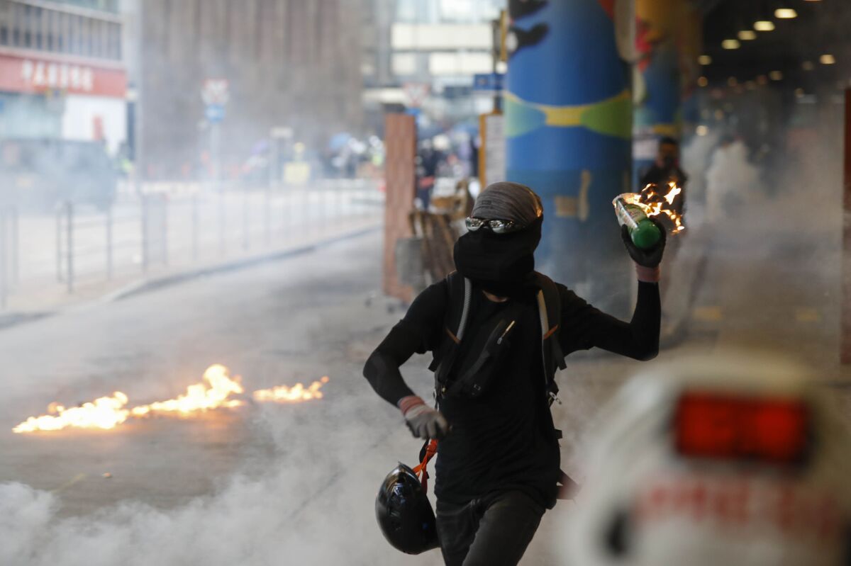 A protester prepares to throw Molotov cocktail in Hong Kong on Sunday.