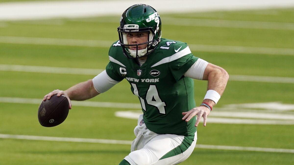 New York Jets quarterback Sam Darnold runs during a game against the Los Angeles Rams.