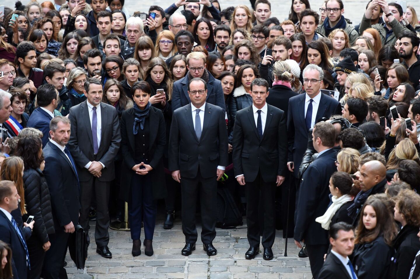 French President Francois Hollande, center, stands with government officials to observe a minute of silence Nov. 16 at the Sorbonne University in Paris.