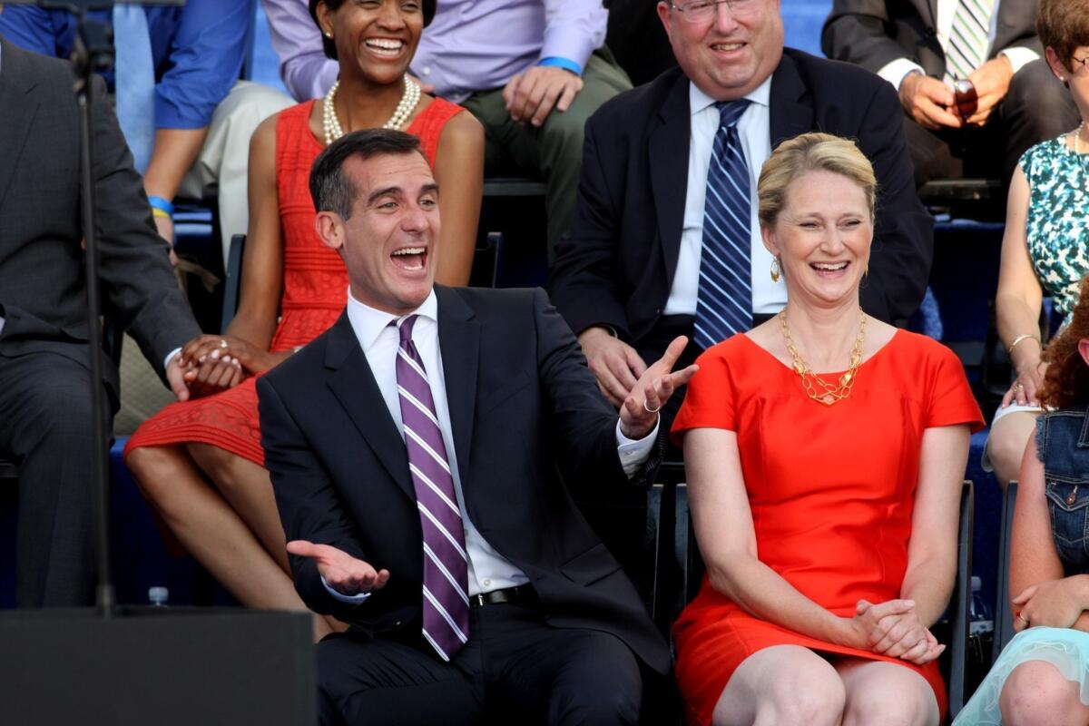 Los Angeles Mayor Eric Garcetti is seen with his wife, Amy Wakeland, in June 2013 at his swearing-in. The couple appeared on a country music radio station Wednesday.