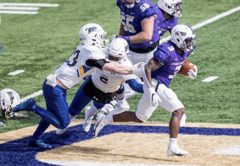 FILE - James Madison running back Solomon Vanhorse (3) breaks away from Morehead State defensive back Cooper Krezek (23) during the first half of an NCAA college football game in Harrisonburg, Va., in this Saturday, Feb. 20, 2021, file photo. James Madison remains solidly atop the STATS Perform FCS Top 25, but the Dukes could go into the playoffs on April 24 having played once in six weeks.(Daniel Lin/Daily News-Record via AP, File)