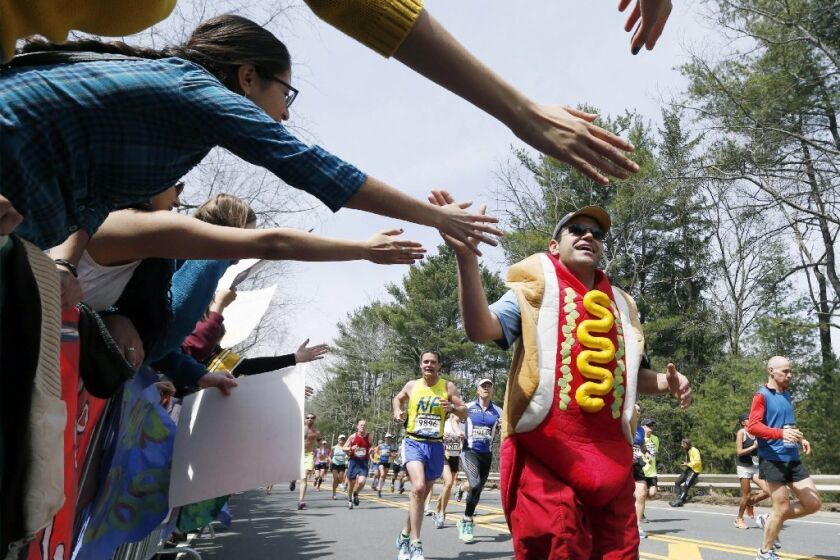 In this file photo, a man dressed as a hot dog runs through Wellesley, Mass., during the the Boston Marathon, before the race was ended by a bombing attack.