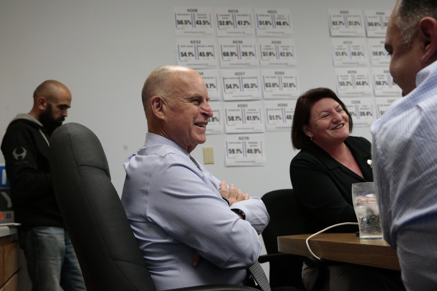 Relaxed after his easy victory over challenger Neel Kashkari, Gov. Jerry Brown checks the progress of state Democratic candidates at campaign headquarters with former Assembly Speaker John Perez, right, and current Speaker Toni Atkins.