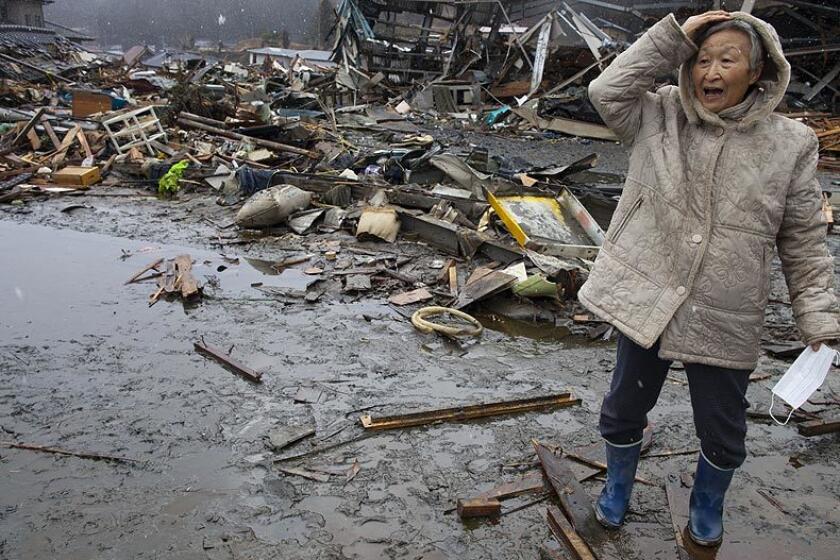 A woman in Kesennuma, Japan, visits the rubble of the village where she had her home. The area was destroyed in the tsunami that followed the massive earthquake that struck March 11 off Japan. As the death toll continues to rise, the country is struggling to contain a potential nuclear meltdown after the Fukushima Daiichi plant was seriously damaged in the disaster.