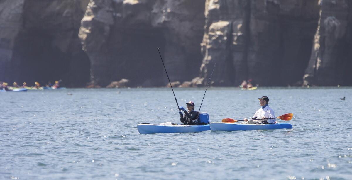 Trina Williams (left) and Russell Castiglione (right) fish off of La Jolla Cove in the Matlahuayl marine protected area on August 9, 2019 in San Diego, California. After spotting them, WILDCOAST employees approached them and handed them literature to explain they were fishing in a protected area. 