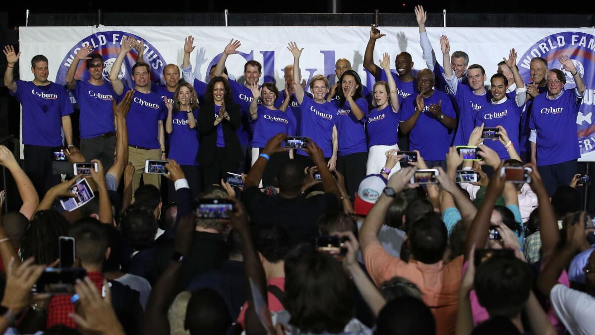 Twenty-one of the candidates seeking the Democratic Party presidential nomination pose together after House Majority Whip James E. Clyburn's "World Famous Fish Fry" on Friday in Columbia, S.C.