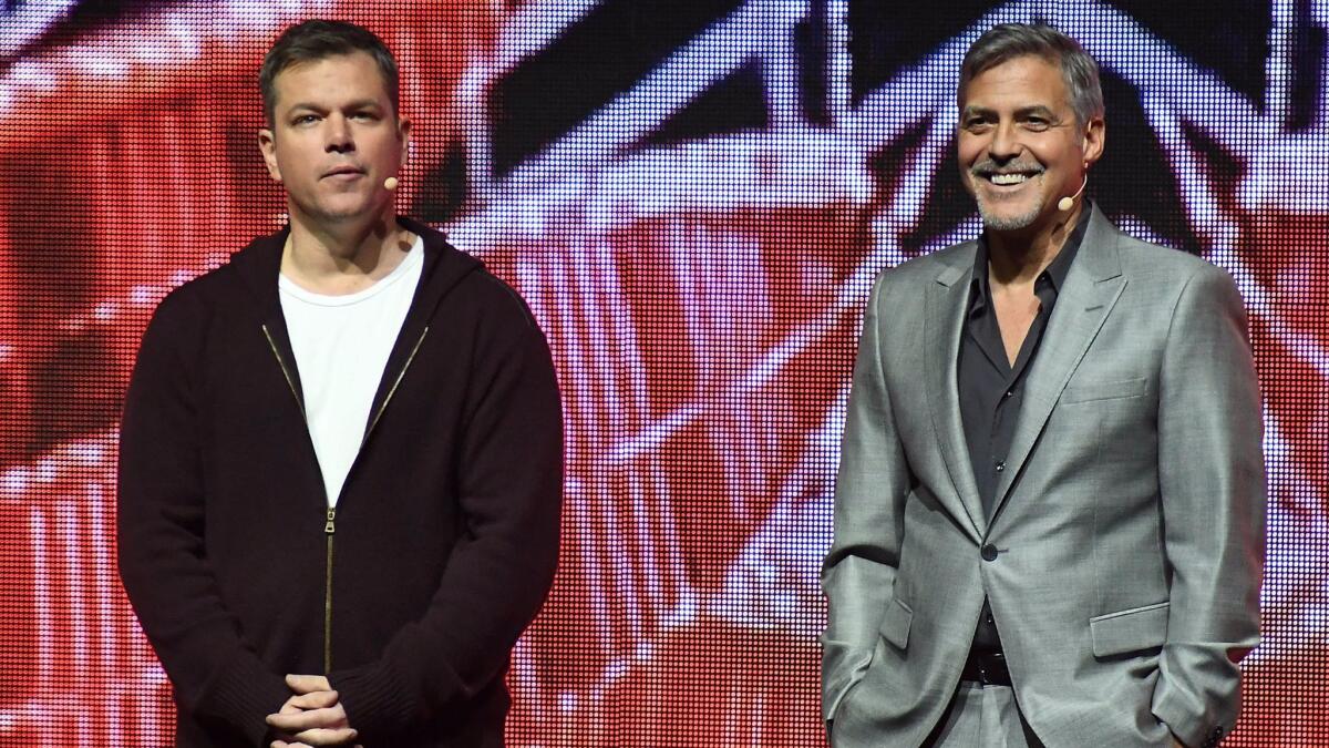 Matt Damon and George Clooney onstage at Paramount Pictures' CinemaCon 2017 presentation.