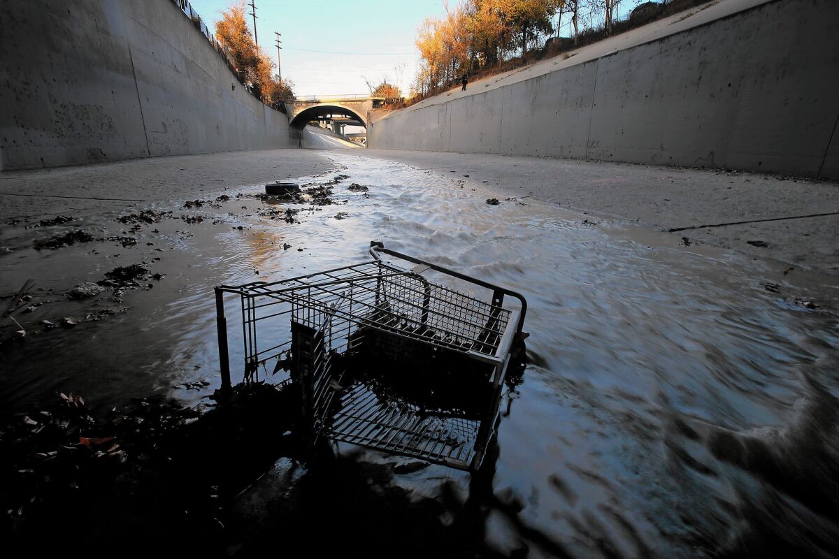 A grocery cart lies in the stream of the Arroyo Seco at its confluence with the L.A. River.