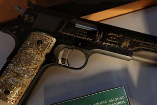 A gun decorated with gold belonging to Mexican drug lord of the Gulf Cartel, Osiel Cardenas Guillen, is displayed in the Drugs Museum at the headquarters of the Ministry of Defense in Mexico City.