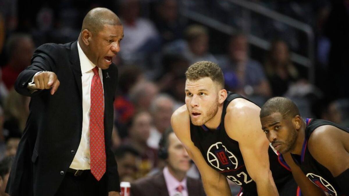 The Clippers' Blake Griffin, center, and Chris Paul get an earful from Coach Doc Rivers during a March 18 game against the Cleveland Cavaliers.