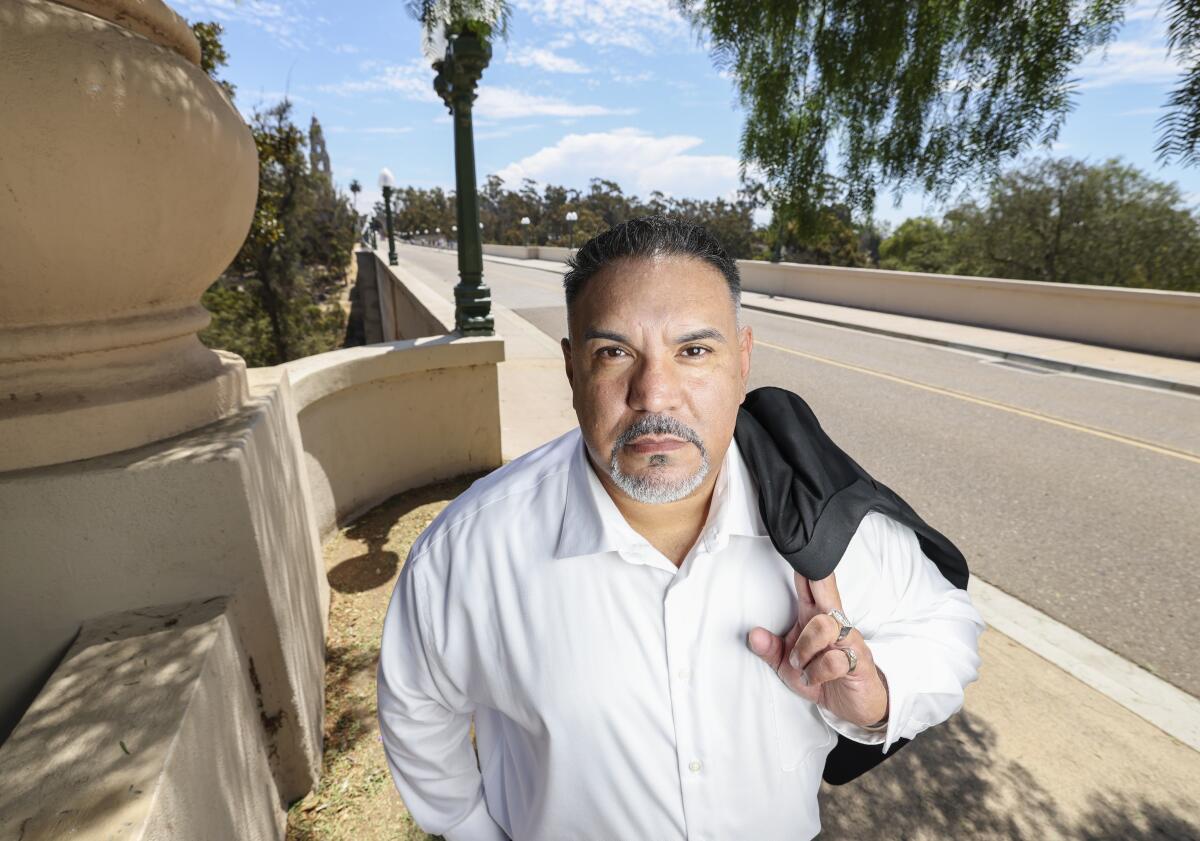 Author Jesse Leon poses for photos along Laurel Street by the Cabrillo Bridge on Friday, Aug. 12, 2022.
