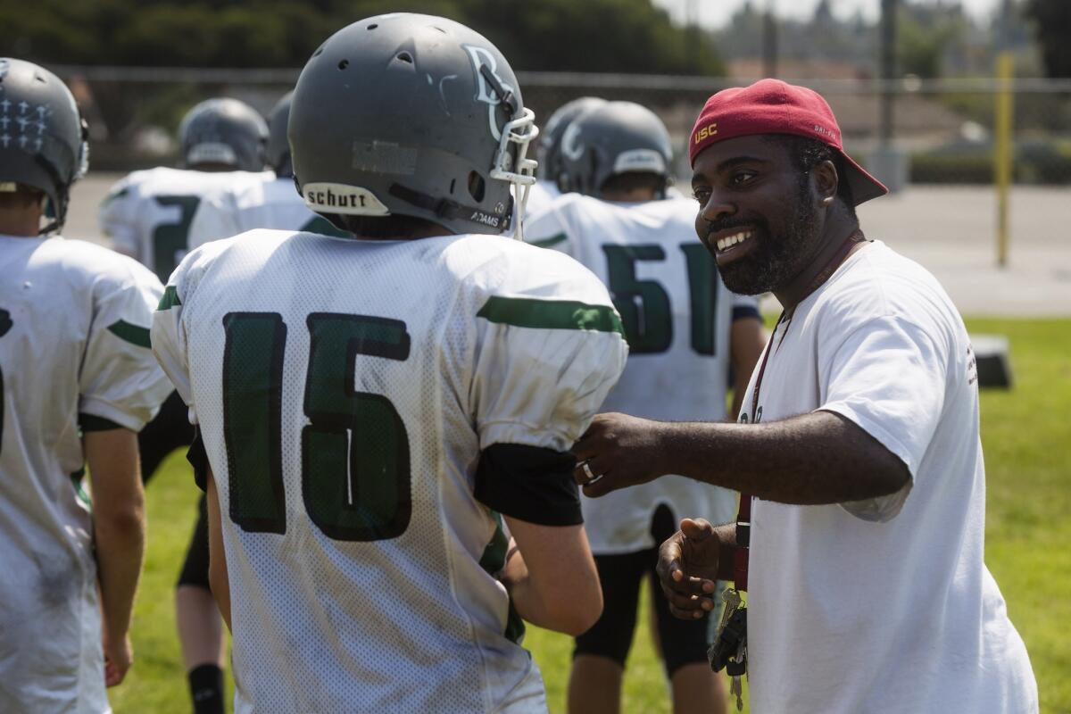Brethren Christian coach Leon Green, seen joking with Slater Jones on Aug. 10, 2018, returns for his second year in charge of his alma mater.