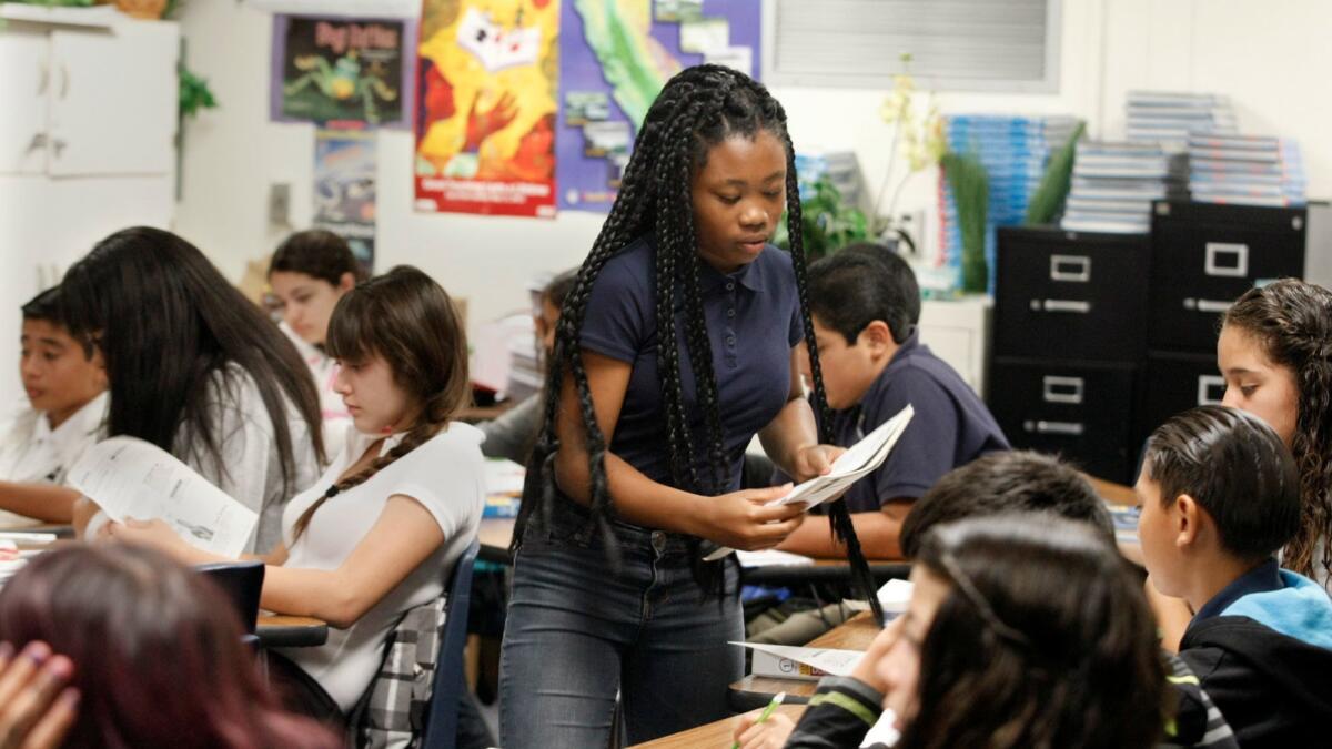 Sherrie Thomas, 13, passes out papers in her eighth-grade pre-Advanced Placement science class at Lennox Middle School on August 22, 2013. California's students performed below average on a national science test in 2015, according to results released late Tuesday.