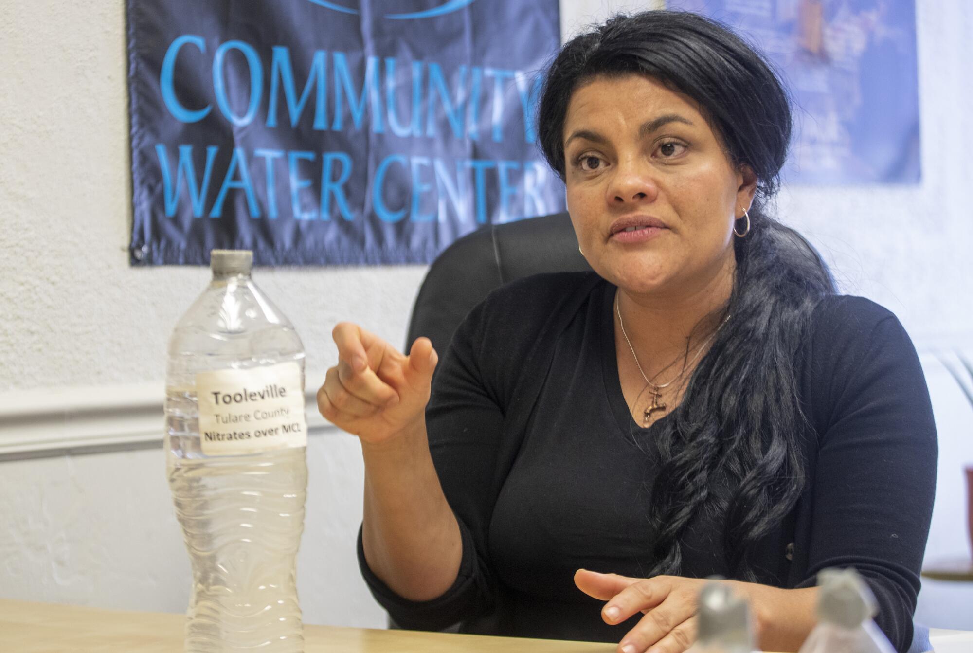 Susana de Anda, director of the Community Water Center in Visalia, gestures while talking.
