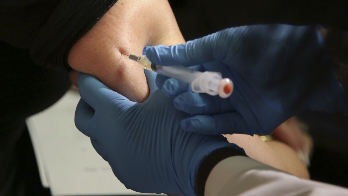 A woman receives a measles, mumps and rubella vaccine at the Rockland County Health Department in Pomona, N.Y.