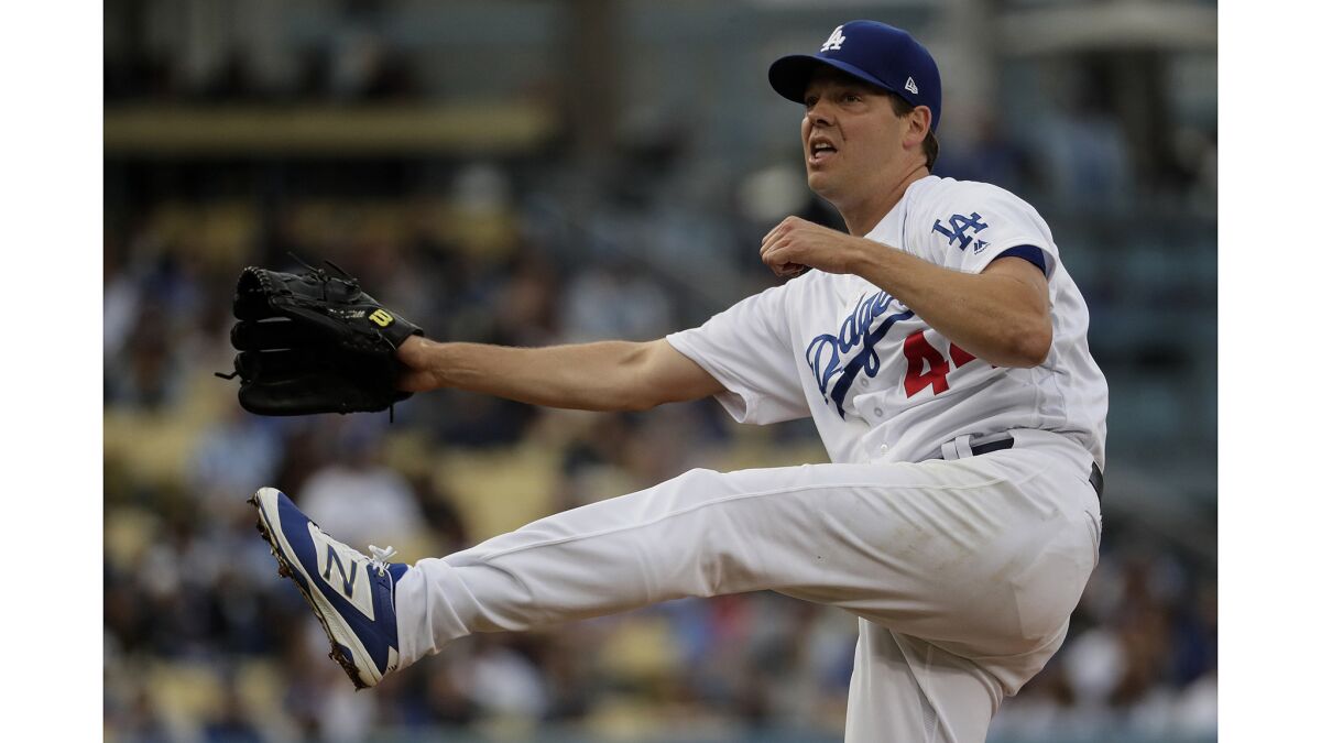 Dodgers pitcher Rich Hill pitches in the third inning against the Giants.